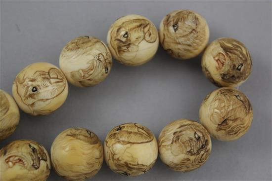 Two Japanese carved ivory necklaces, early 20th century,